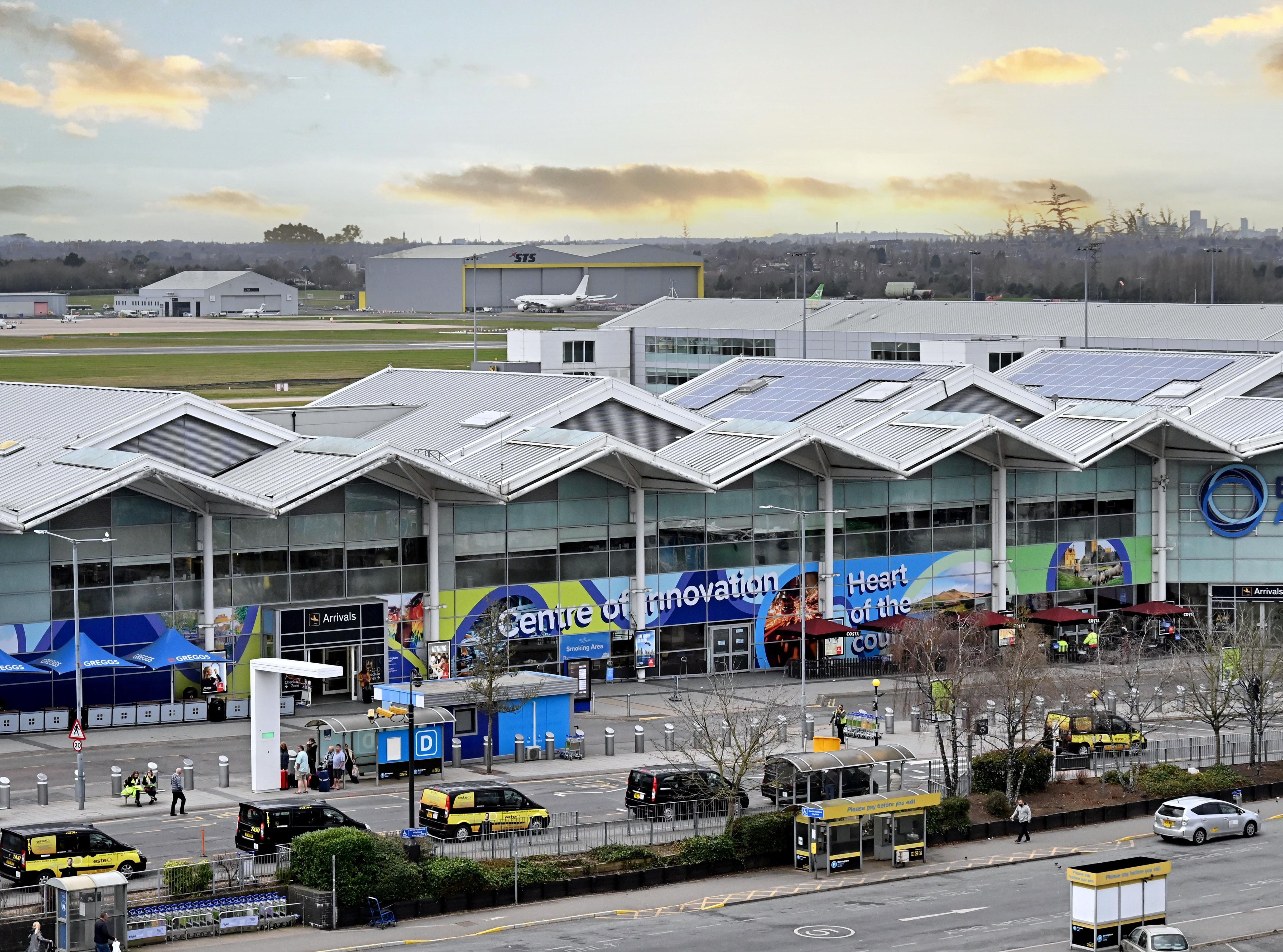 'Get there three hours before if you want food and a drink' – Fuming airline passengers queue outside entrance to Birmingham Airport