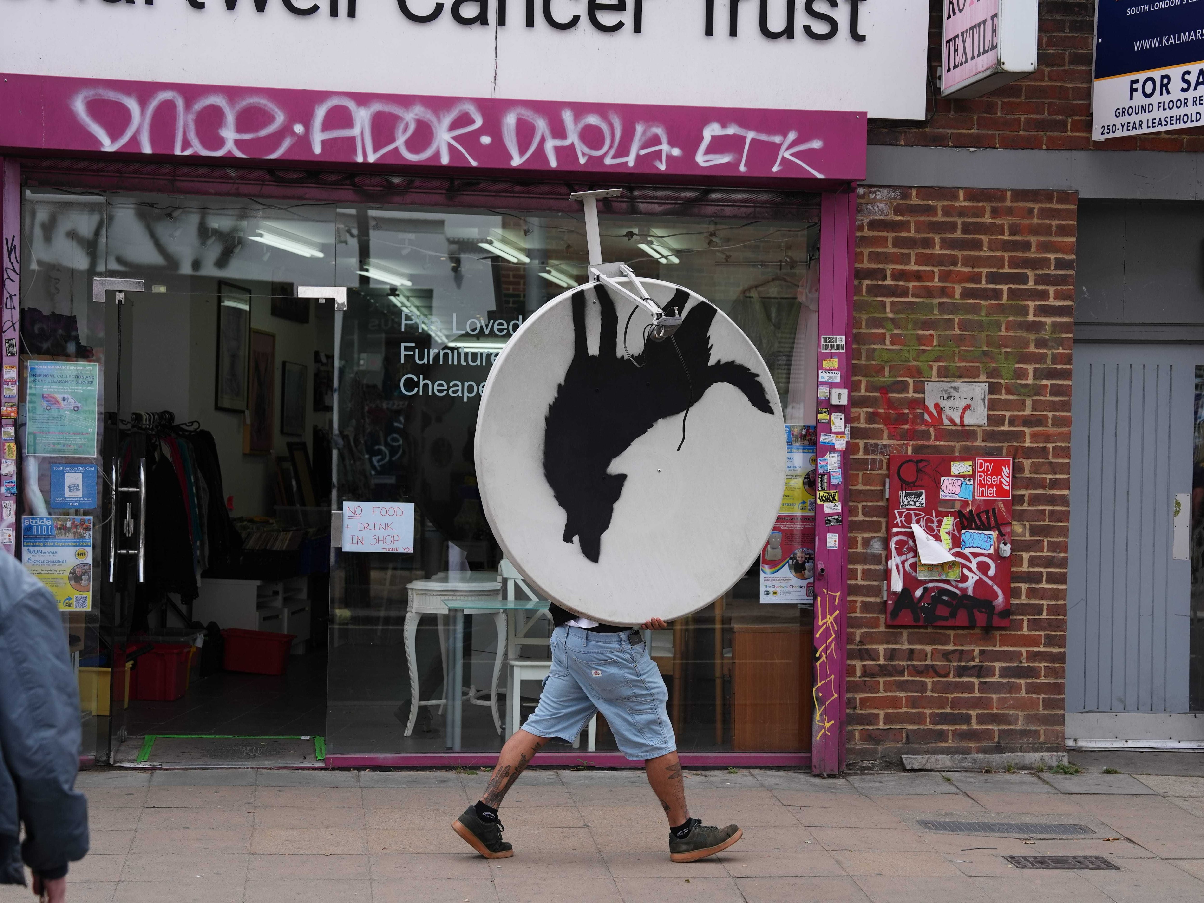 Banksy’s howling wolf artwork removed less than an hour after unveiling