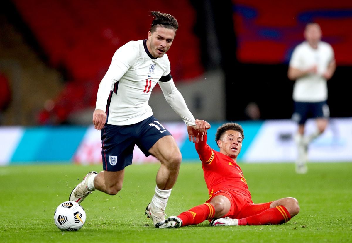 England's Jack Grealish (left) and Wales' Ethan Ampadu battle for the ball