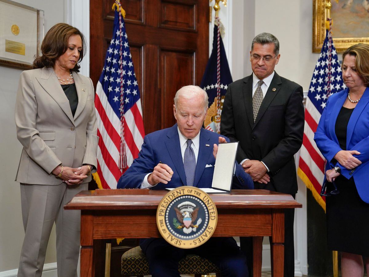 President Joe Biden signs an executive order on abortion access at an event in the Roosevelt Room of the White House