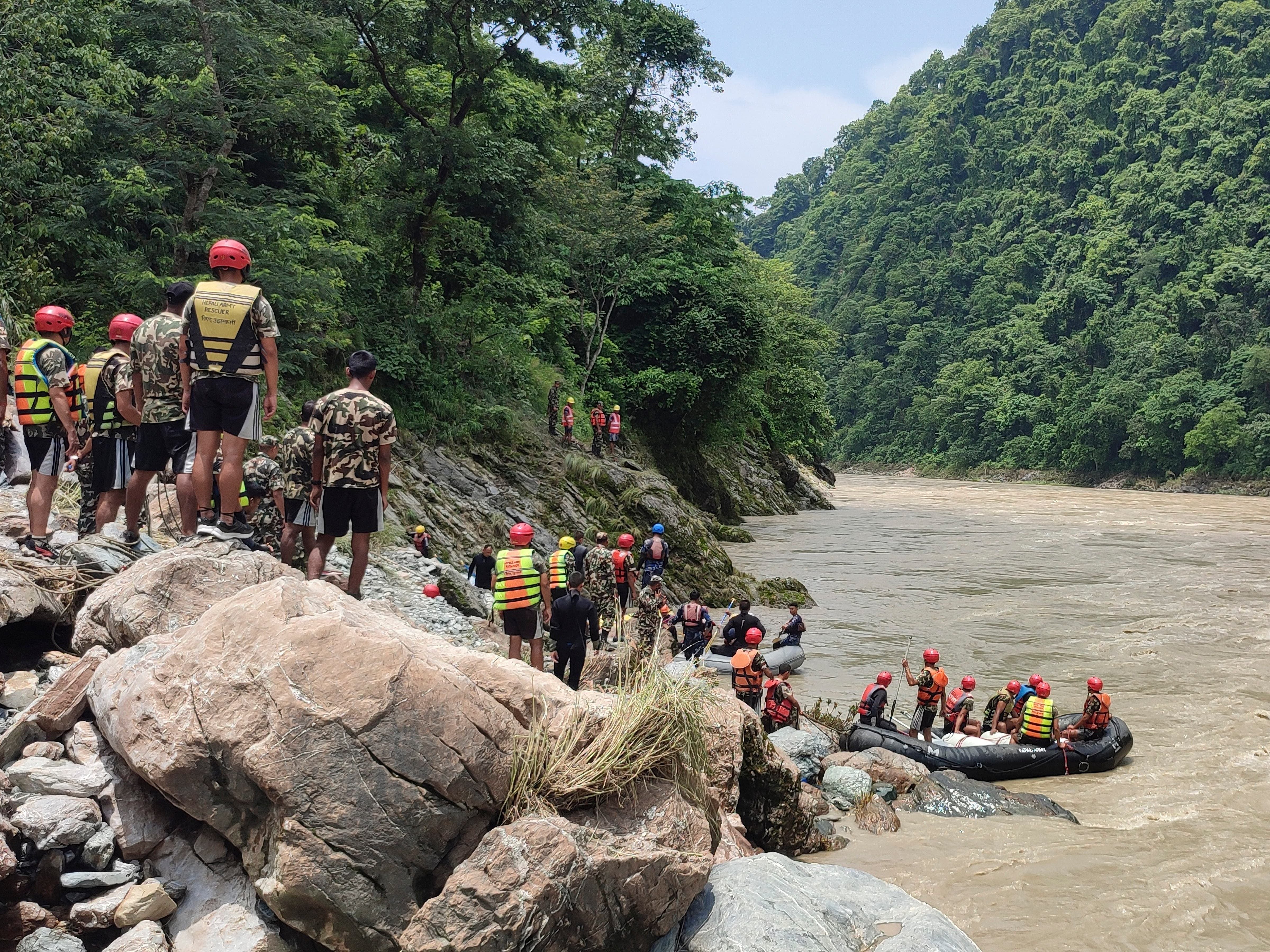 Nepal confirms 65 people on board buses missing in river, as 14 bodies recovered