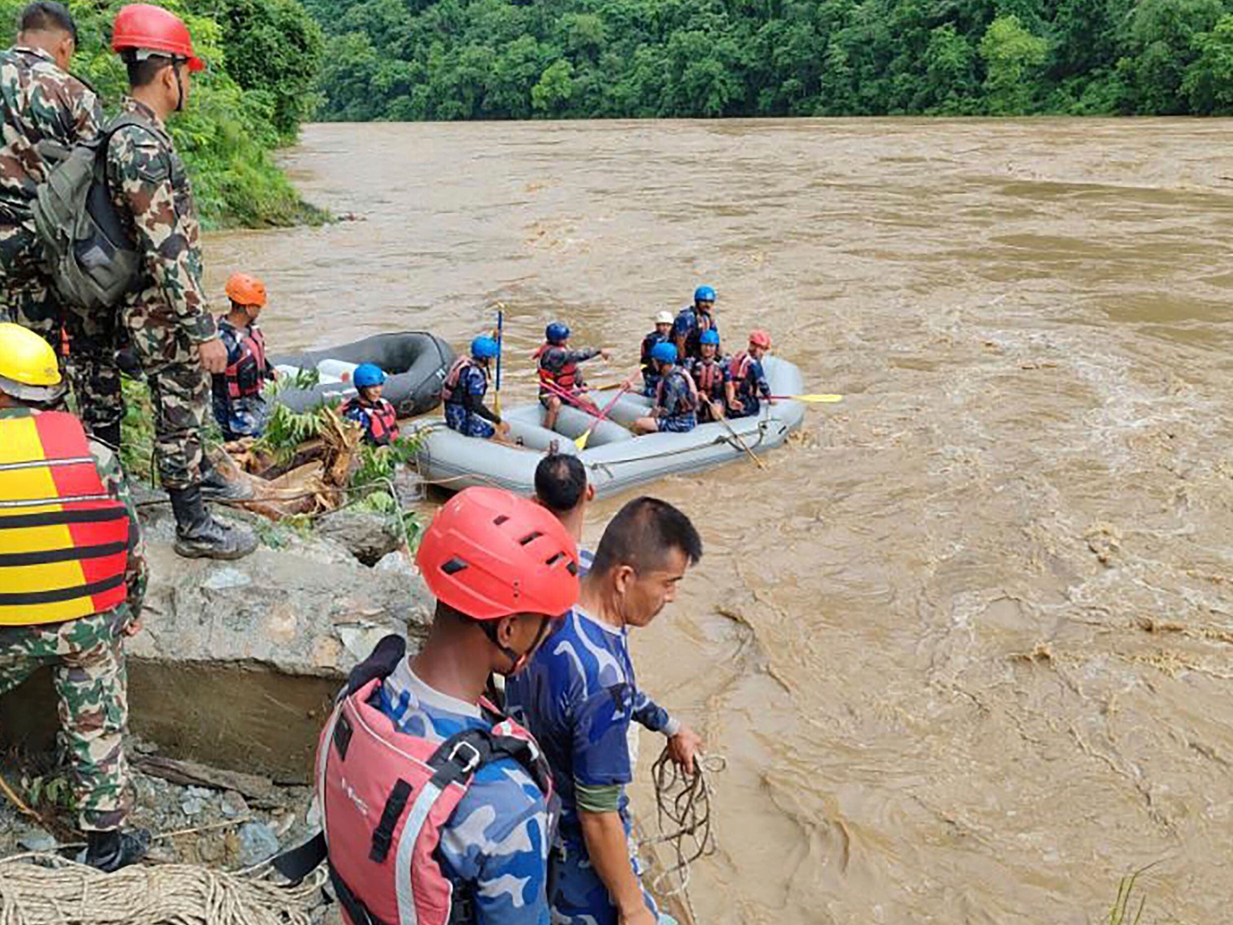 Two buses carrying at least 60 swept into a river by a landslide in Nepal