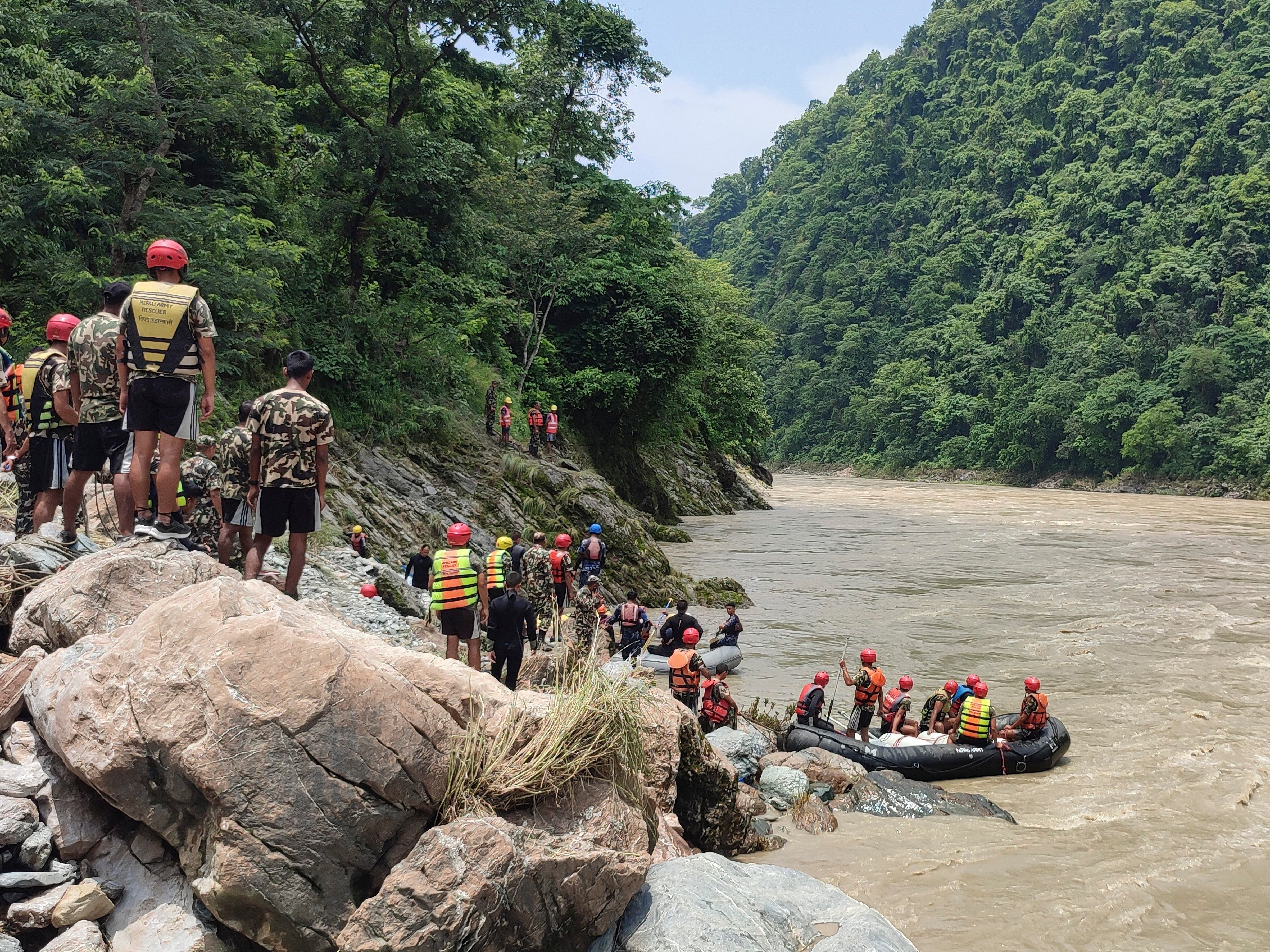 Rescuers recover first body after buses swept into river in Nepal