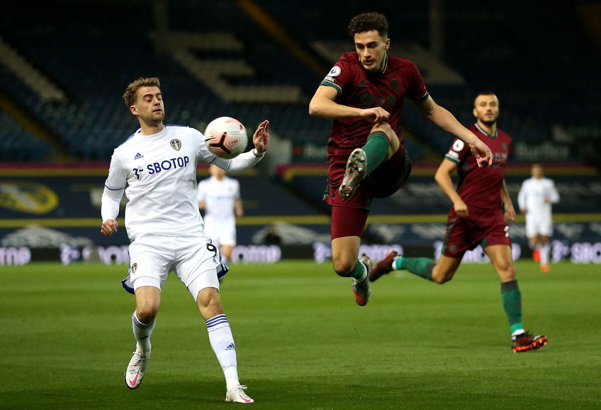 Patrick Bamford of Leeds United and Max Kilman of Wolverhampton Wanderers fight for the ball (PA)
