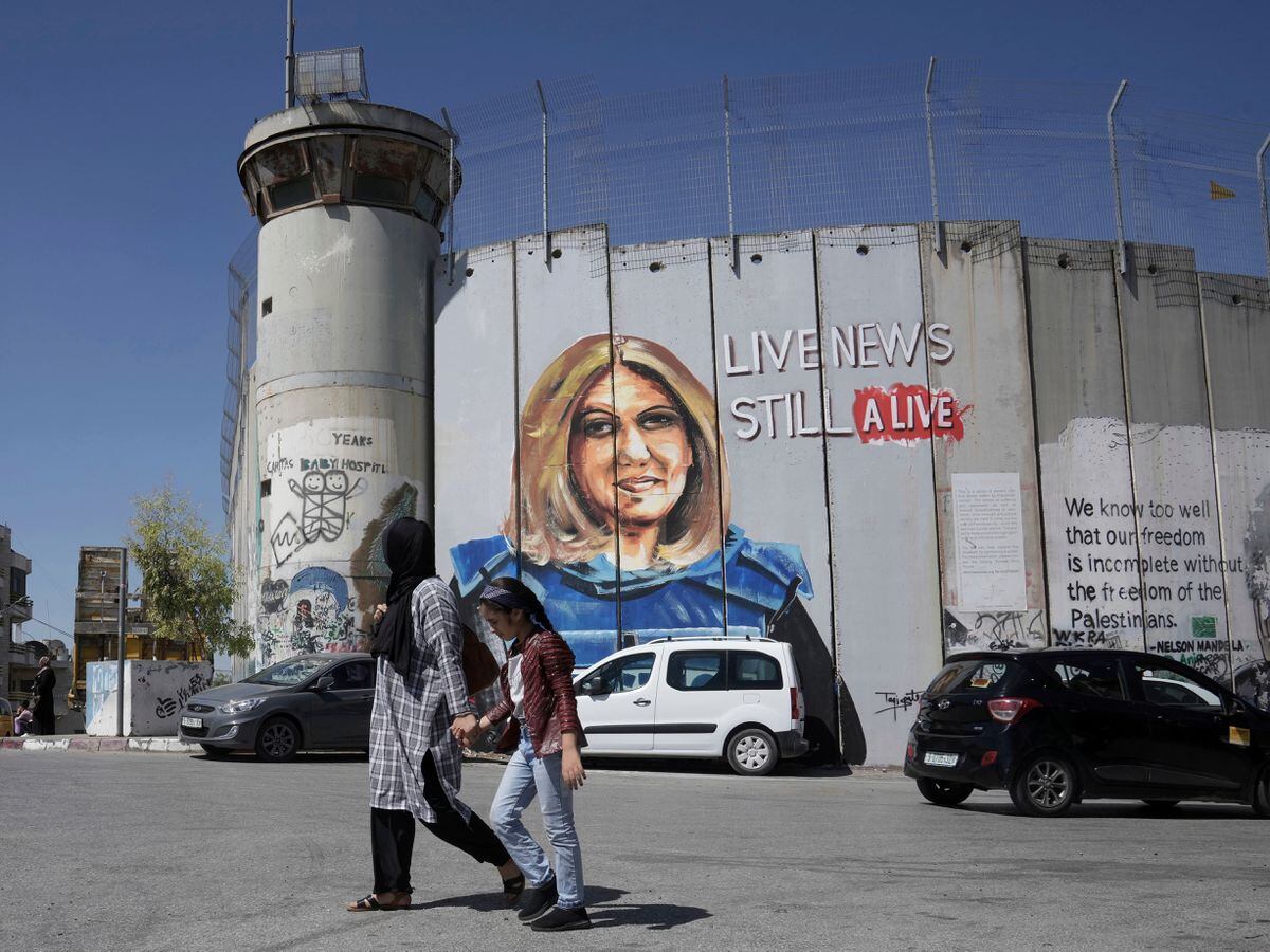 A mural depicting slain Palestinian-American journalist Shireen Abu Akleh adorns part of Israel's controversial separation wall in the West Bank city of Bethlehem