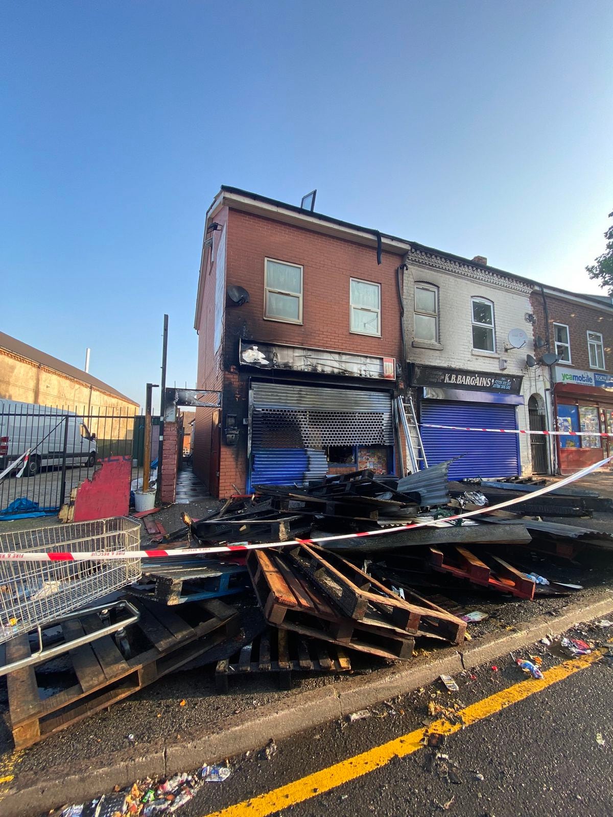 Shop front destroyed in fire as crews stop blaze from spreading to ...