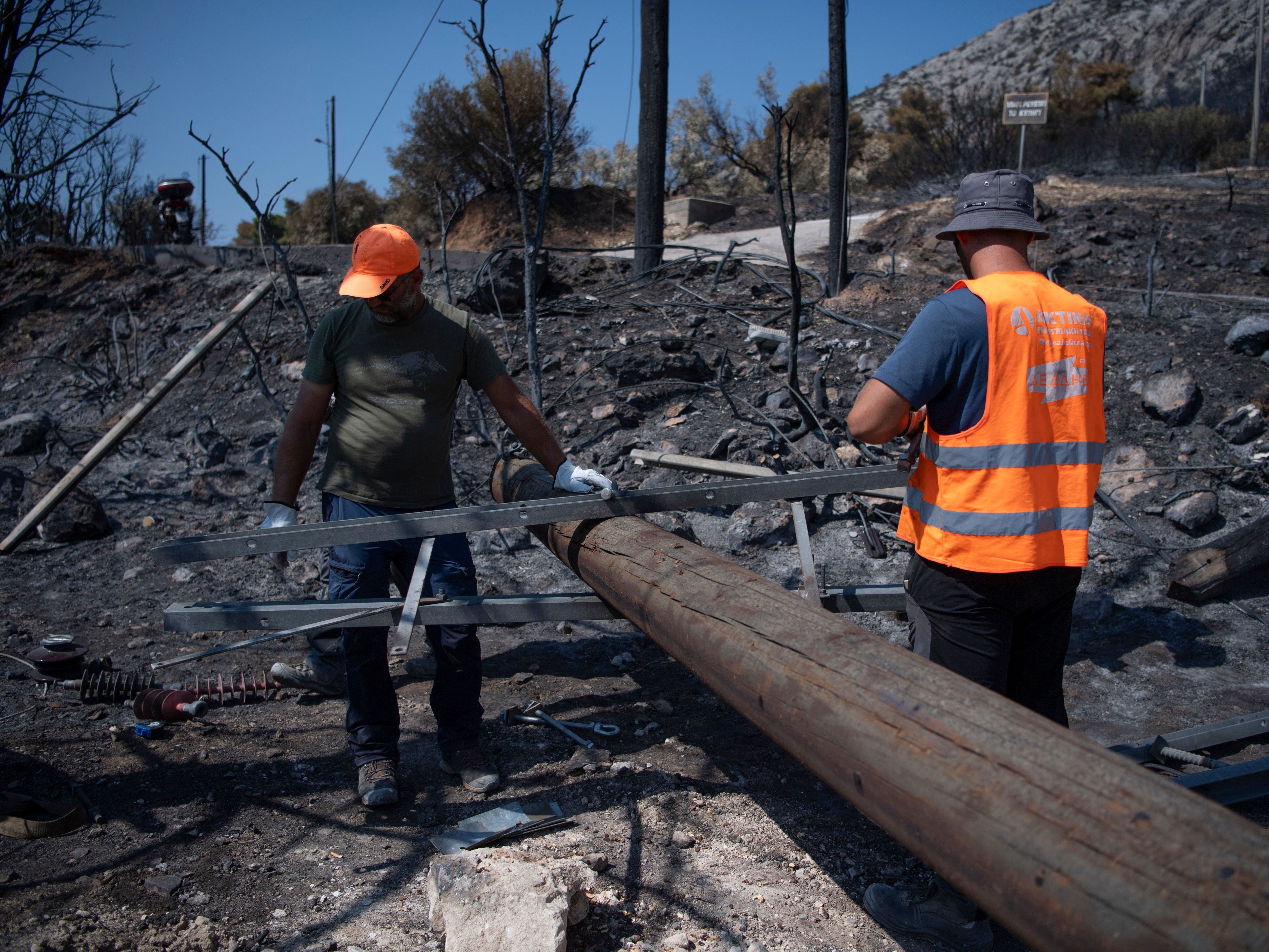 Greek fire officials arrest two for arson as wildfires continue to burn