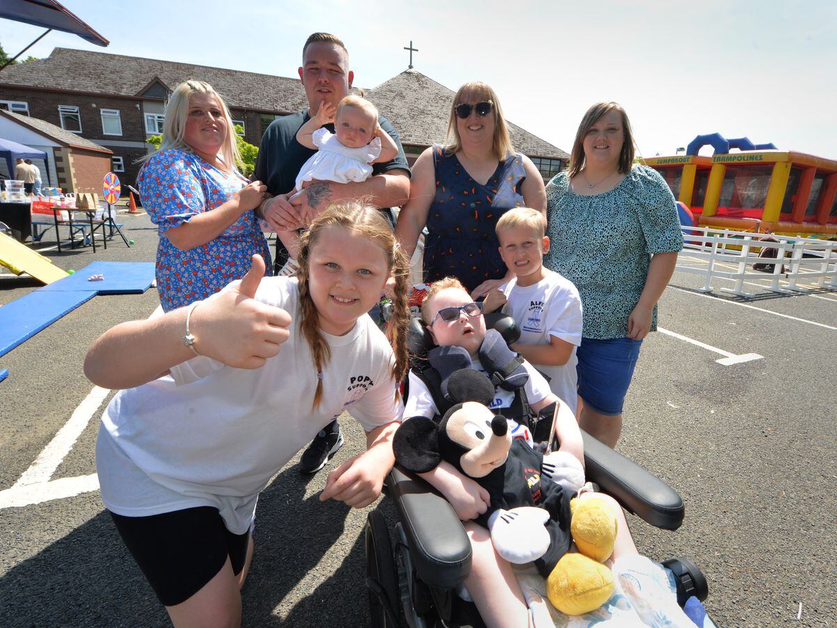 WOLVERHAMPTON PIC MNA PIC  DAVID HAMILTON PIC EXPRESS AND STAR 16/7/22 Fundraising for (centre) Reuben Mills, aged 5, (front) Poppy Mills, 9, (left-right) Kirsten Archer, Christopher Mills, Freya Mills, aged 11 months, Danielle Corns, Alfie Mills, 6, and Laura Curtis, at Corpus Christi Social Centre, Wolverhampton..