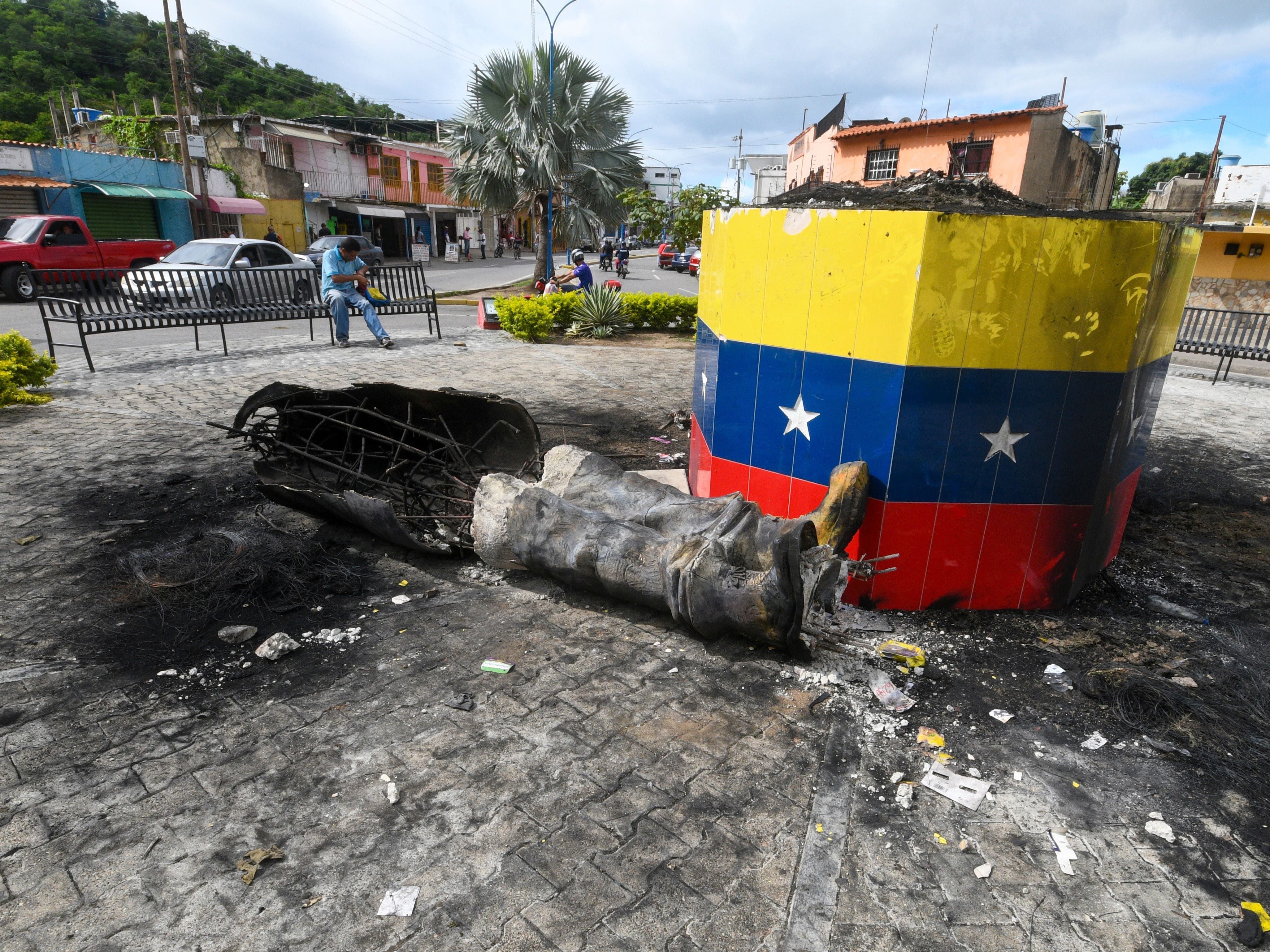 Hugo Chavez statues toppled across Venezuela in post-election unrest