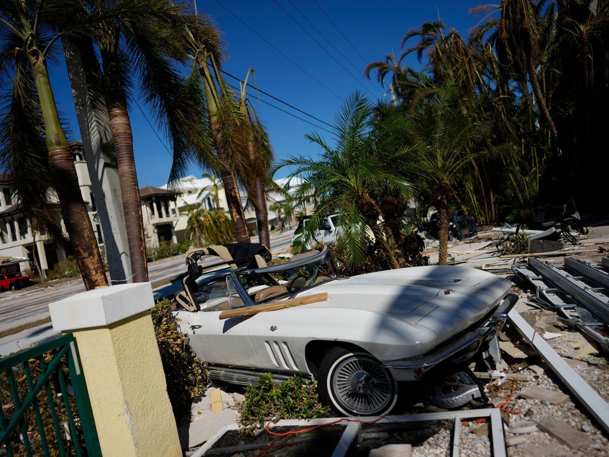 A classic sports car parked where it landed after Hurricane Ian