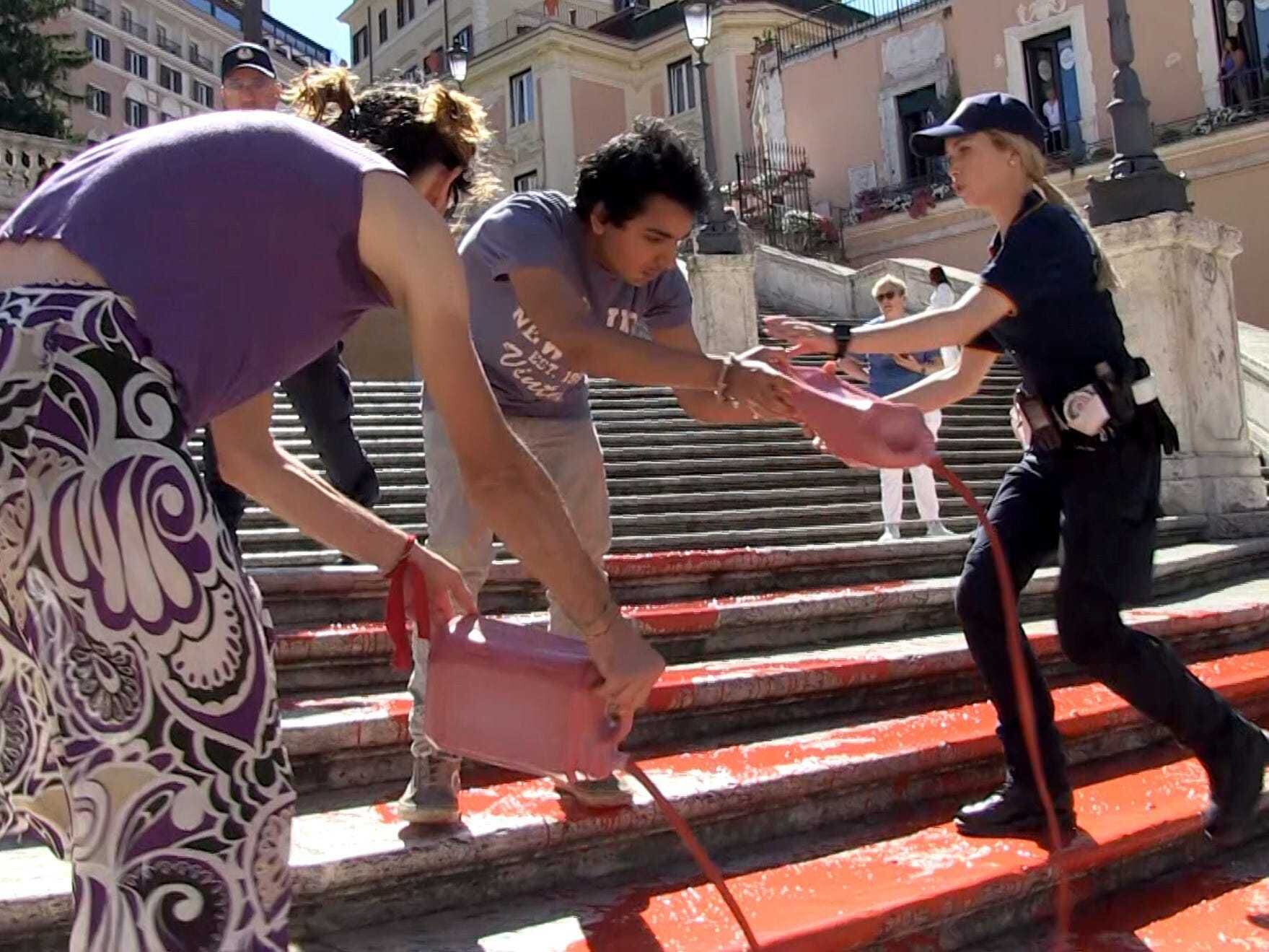 Activists pour paint down Rome’s Spanish Steps in outrage over femicide in Italy