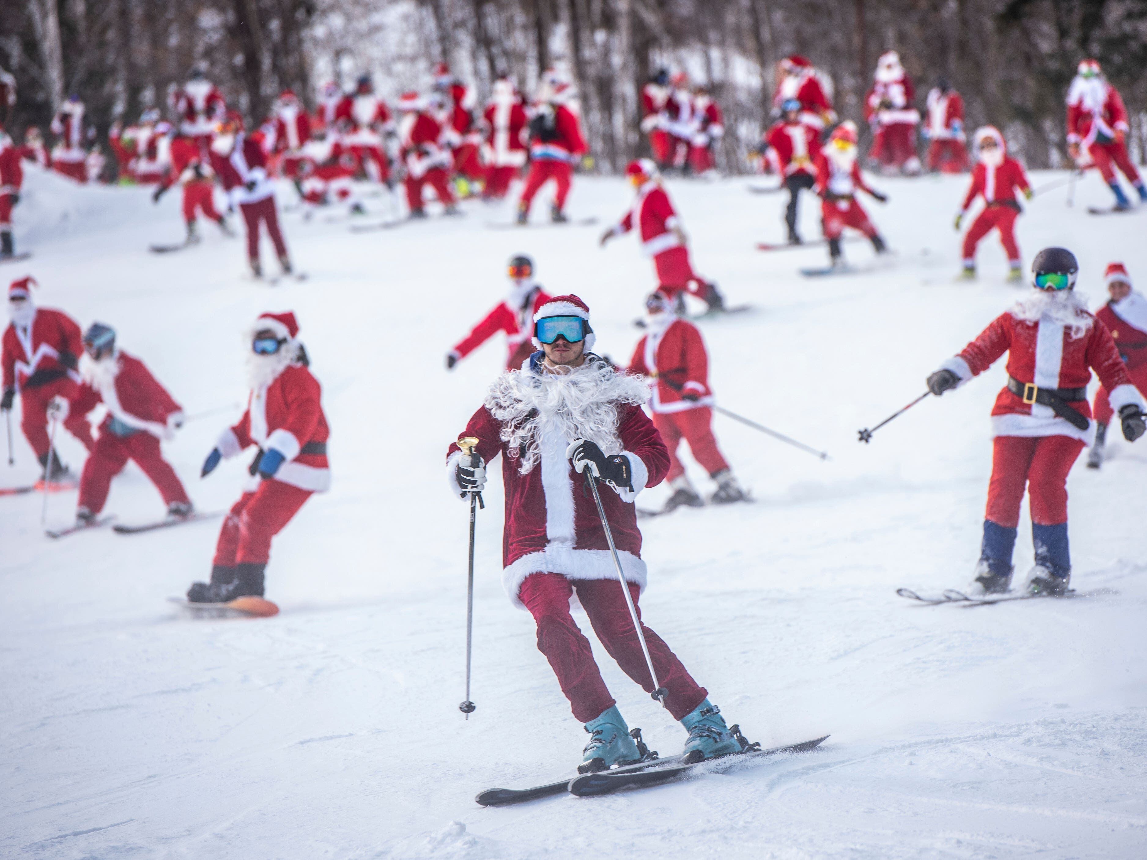 Skiing and snowboarding Santas take to the slopes for charity