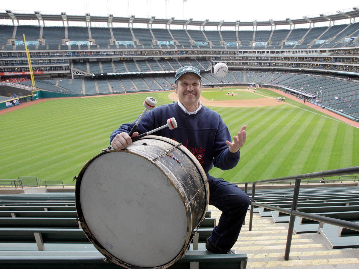 Cleveland fan John Adams puts out his always-present bass drum in his usual midfield seat before a baseball game in Cleveland in April 2011