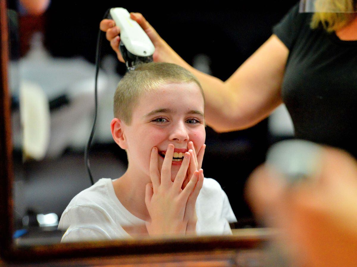 Albion barber cuts hair, supports children in community