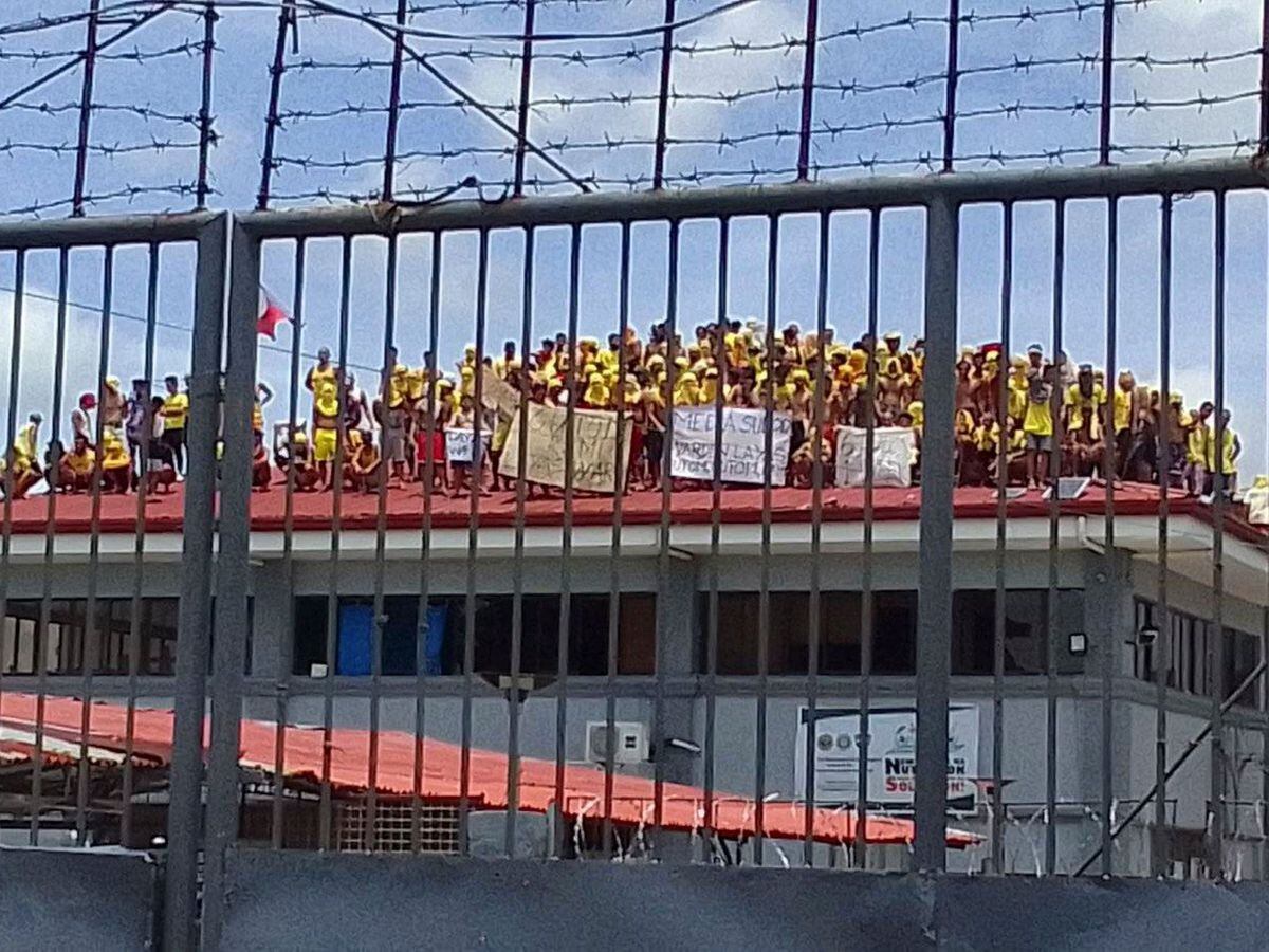 Filipino prisoners protest on the roof of a prison building in Pototan town, Iloilo province, central Philippines