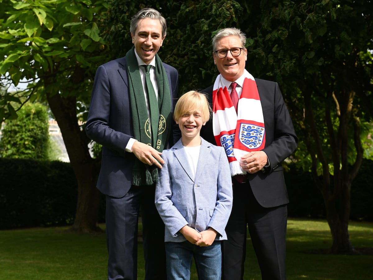 Dublin boy treated for rare illness presents premiers with football shirts