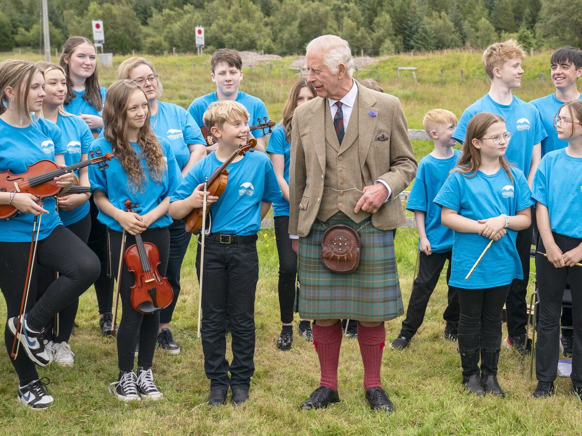 King battles midges on visit to Highland peat bog declared world heritage site