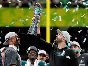 Philadelphia Eagles head coach Nick Sirianni, right, lifts the Vince Lombardi Trophy next to quarterback Jalen Hurts