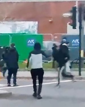 Footage shows the youths running through roads towards each other.