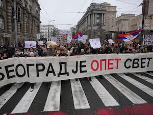 Students carrying a banner reading 'Belgrade is the World again'