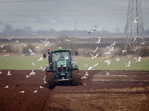 A tractor ploughs a field (Danny Lawson/PA)