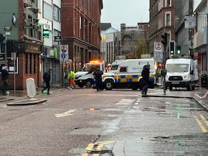 A clean-up operation under way in Castle Street in Belfast following a night of high winds amid Storm Darragh