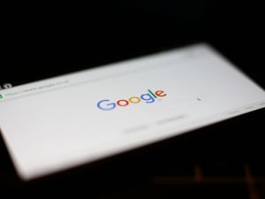 A Google logo on the screen of a mobile phone