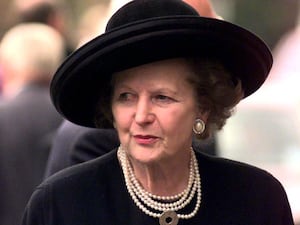 Margaret Thatcher wearing a black hat at a funeral