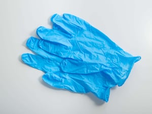 Pair of blue medical gloves on white background top view.