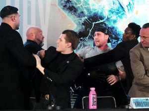 Tommy Fury (left) and Darren Till (centre) are held apart by security during a press conference