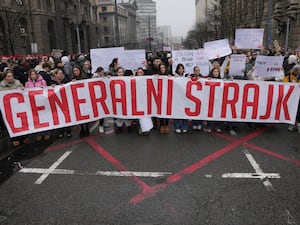 Students hold a banner that reads 'general strike' and stop traffic to commemorate the 15 victims killed after a railway concrete canopy fell in November, to demand accountability for the tragedy in Belgrade, Serbia