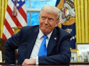 President Donald Trump speaks with reporters in the Oval Office at the White House on Tuesday