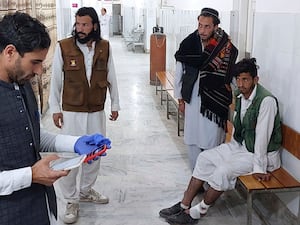 An injured victim awaits hospital treatment