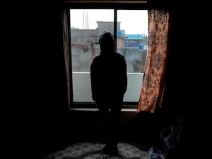 An Afghan refugee woman, who asked not to be identified fearing it could lead to her capture, poses for a photographer following her interview with The Associated Press in Islamabad, Pakistan