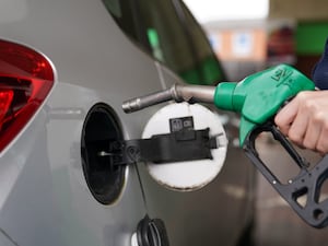 A person filling a car with petrol