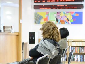 Patients in a waiting room of a GP surgery