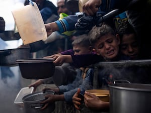 Palestinians line up for a meal