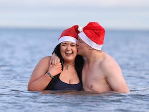 Rebecca Browne and Joel McElwee take part in the annual Christmas Eve swim at Helen’s Bay, Co Down