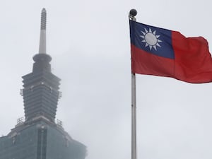 A Taiwan national flag flutters near the Taipei 101 building at the National Dr Sun Yat-Sen Memorial Hall in Taipei, Taiwan