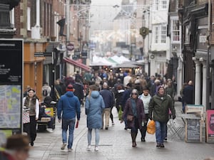 Last-minute shoppers on Christmas Eve make their way along the High Street in Winchester, Hampshire