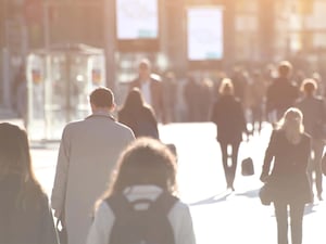 Commuters walking along a street