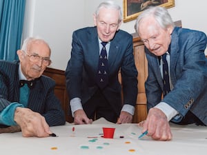 Bill Steen, Peter Downes and Lawford Howells celebrate the 70th anniversary of competitive tiddlywinks. (Cambridge University/PA)