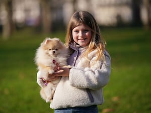 Rozalyn Merrett, nine, from Nottinghamshire, with Rosa, an 11-month-old Pomeranian, during a launch event for Crufts 2025 in Green Park, London