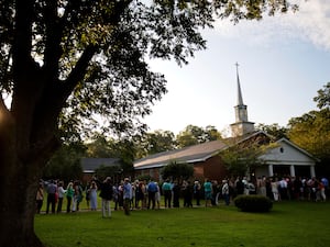 People wait in line outside Maranatha Baptist Church in Plains