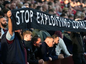 Aston Villa fans protest with a banner that reads ‘stop exploiting loyalty’ during the Premier League match at Villa Park