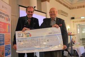 Councillor Richard Cox presents a cheque on behalf of Lichfield District Community Lottery to Simon Price (left) patron of the We Love Lichfield fund.