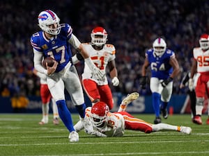 Buffalo Bills quarterback Josh Allen slips past Kansas City Chiefs cornerback Nazeeh Johnson to score on a 26-yard run