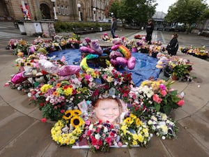 A floral display showing an image of one of the Southport victims