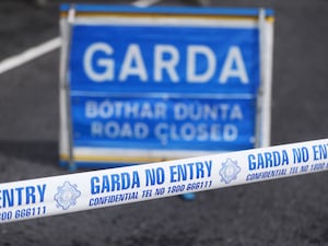 Garda tape and road closed sign