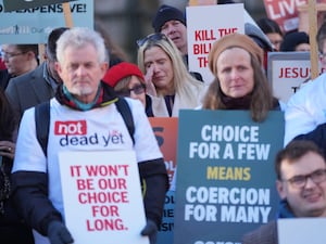 Opponents of assisted dying holding placards